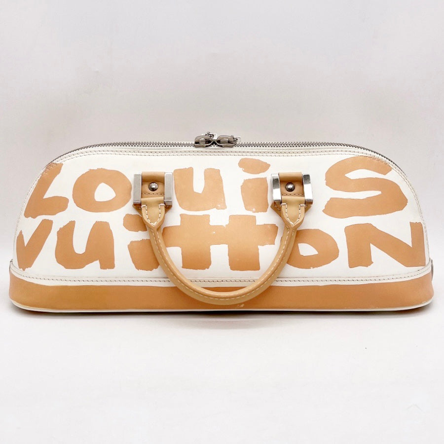 Alma graffiti leather handbag Louis Vuitton Beige in Leather